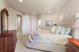 Step into this inviting bedroom, featuring a plush bed and elegant decor.