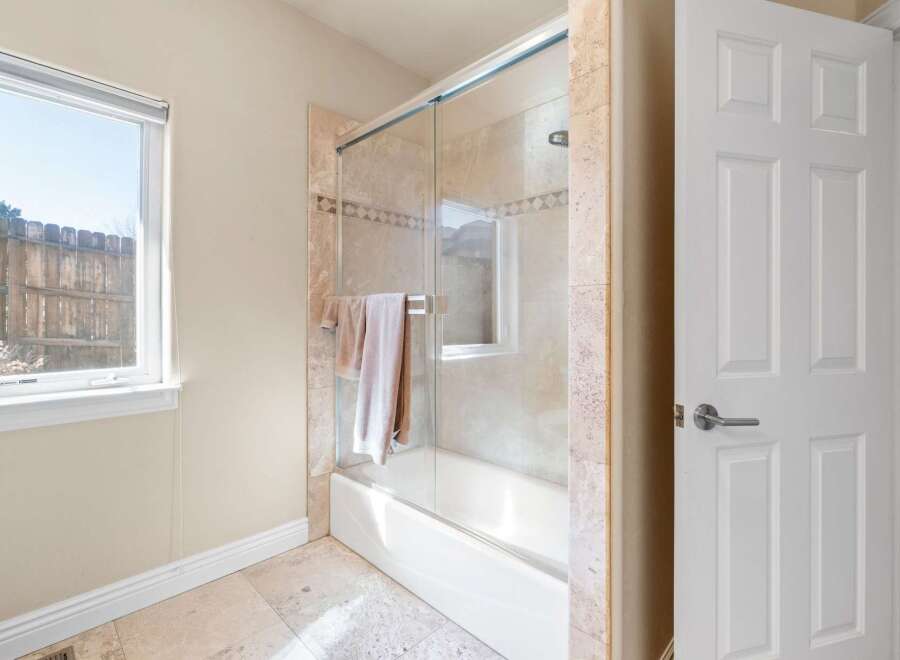Step into a beautifully designed bathroom featuring a modern glass shower enclosure.