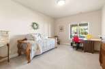 This charming bedroom offers a cozy and inviting atmosphere, perfect for relaxation.