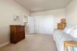 Discover the charm of this inviting bedroom, featuring a warm and inviting atmosphere.