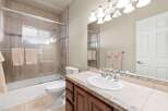 Step into this beautifully designed bathroom, featuring a modern shower with glass doors and elegant tile work.