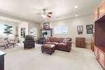 Step into luxury with this stunning living room, featuring a cozy leather sofa, armchair, and ottoman set.