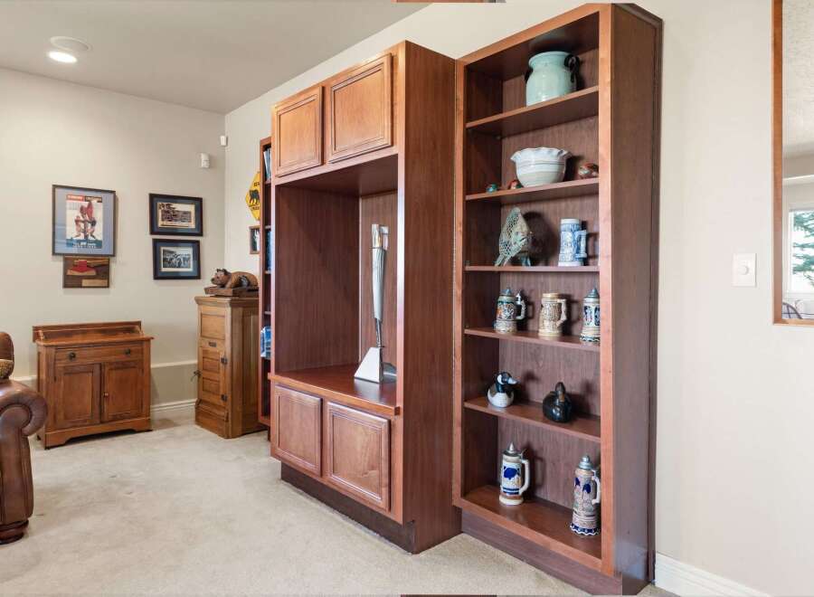 Discover the charm of this inviting living space, featuring custom built-in cabinetry and shelving, perfect for displaying collectibles and adding character.