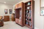 Discover the charm of this inviting living space, featuring custom built-in cabinetry and shelving, perfect for displaying collectibles and adding character.