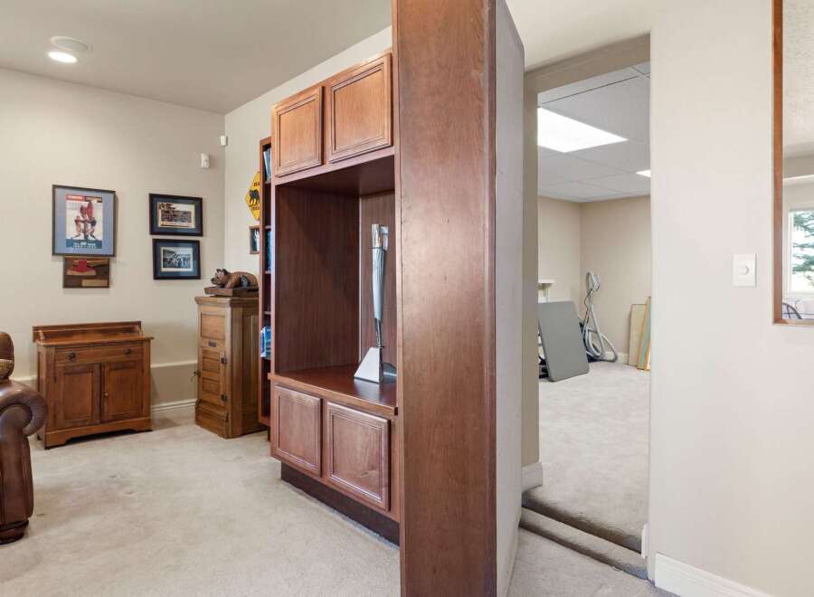 Discover the charm of this inviting living space, featuring rich wooden cabinetry and a cozy ambiance.