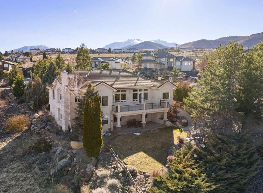 Discover luxury living in this stunning hillside home, boasting breathtaking mountain views and a meticulously landscaped yard.
