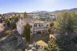 Discover luxury living in this stunning hillside home, boasting breathtaking mountain views and a meticulously landscaped yard.