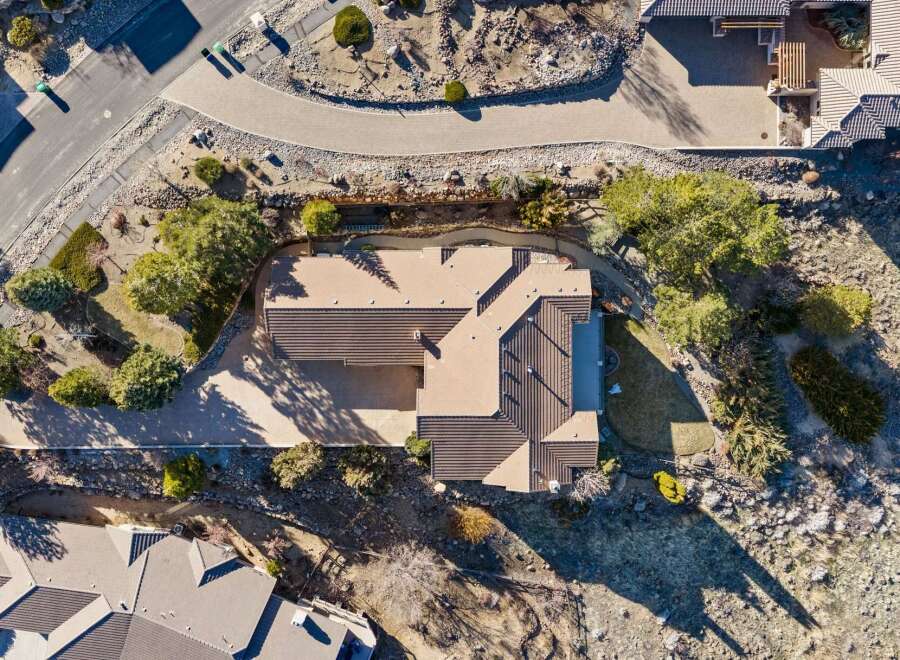 This stunning property boasts a modern design with a beautiful roof and a spacious driveway.