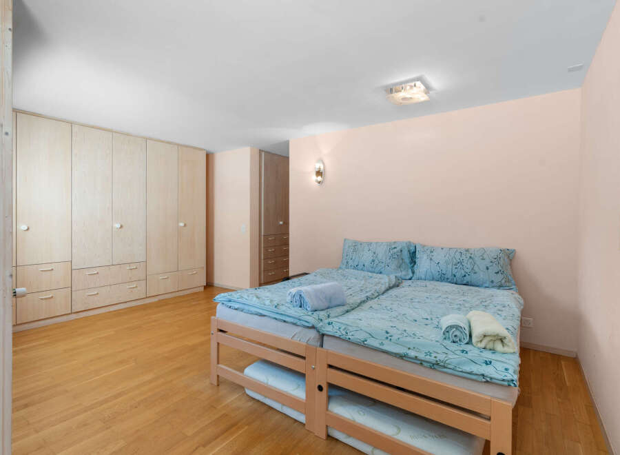 Discover this charming bedroom featuring two comfortable beds adorned with serene blue floral bedding.