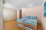 Discover this charming bedroom featuring two comfortable beds adorned with serene blue floral bedding.