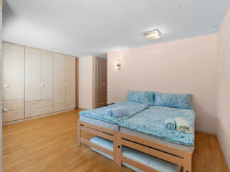 Discover this charming bedroom featuring two comfortable beds adorned with serene blue floral bedding.