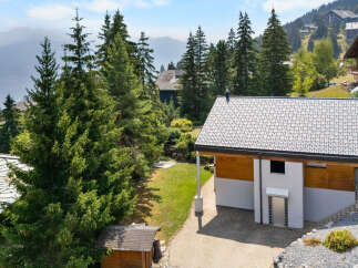 Nestled amidst lush evergreen trees and rolling hills, this charming property offers a serene mountain retreat.