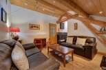 Step into this charming living space featuring exposed wooden beams and a cozy atmosphere.