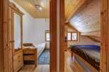 Discover the charm of this cozy bedroom, featuring warm wooden accents and a unique architectural design.