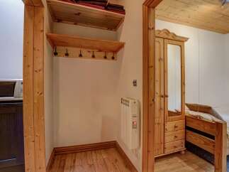 This charming property boasts a cozy interior with a warm, inviting atmosphere.