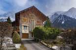 Nestled in a picturesque mountain setting, this stunning property boasts a unique architectural design with a blend of wood and stone.
