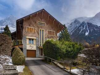 Nestled in a picturesque mountain setting, this stunning property boasts a unique architectural design with a blend of wood and stone.