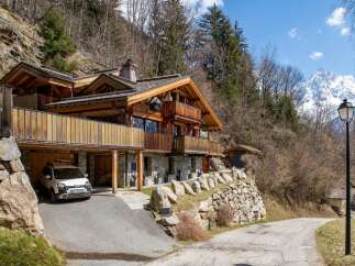 Nestled in a picturesque mountain setting, this stunning chalet offers a perfect blend of rustic charm and modern luxury.