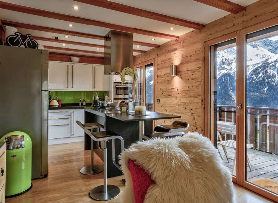 Experience luxury living in this stunning kitchen with breathtaking mountain views.