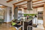 This stunning kitchen boasts a modern design with sleek stainless steel appliances and a stylish island.