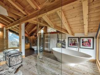 This stunning bathroom showcases a unique blend of rustic charm and modern luxury.