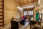This stunning home office boasts a rustic charm with its wooden walls and ceiling, creating a warm and inviting atmosphere.
