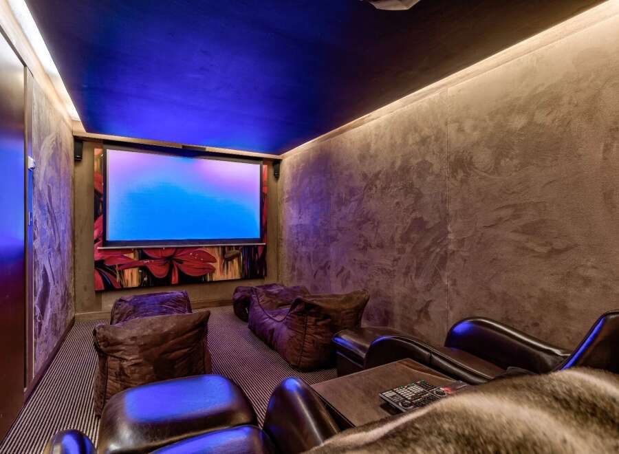 Step into luxury with this stunning home theater! Featuring a large screen, comfortable seating, and ambient lighting, it's the perfect space for movie nights.