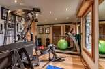 This stunning home gym offers a comprehensive workout experience with state-of-the-art equipment.