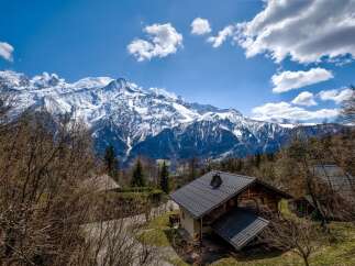 Nestled amidst the majestic snow-capped mountains, this charming chalet offers breathtaking views and a serene escape.