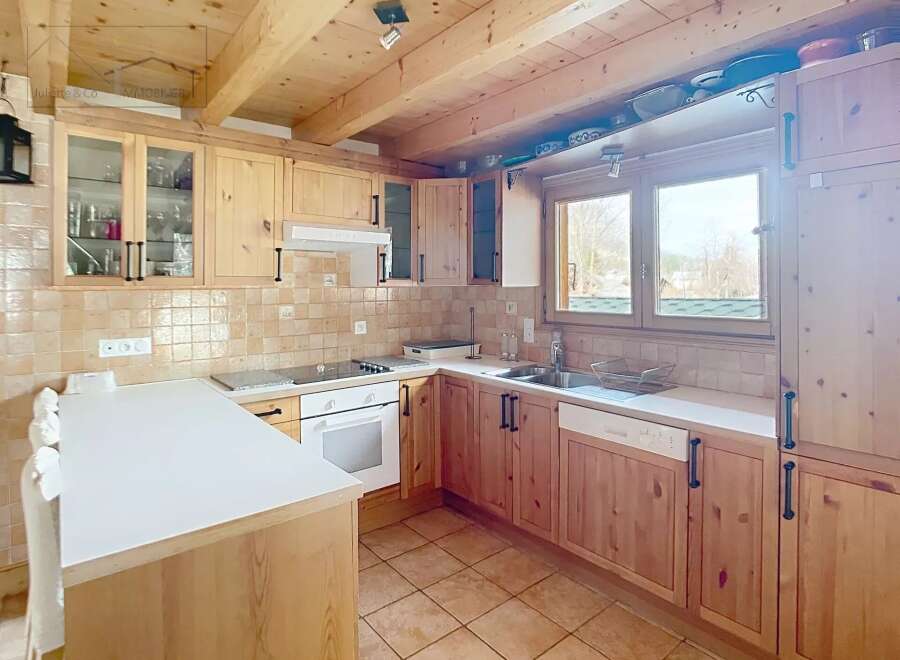 This charming kitchen features warm wooden cabinetry and a bright, inviting atmosphere.
