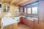 This charming kitchen features warm wooden cabinetry and a bright, inviting atmosphere.