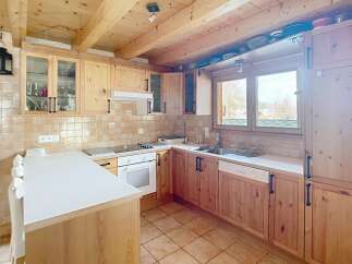 This charming kitchen features warm wooden cabinetry and a bright, inviting atmosphere.