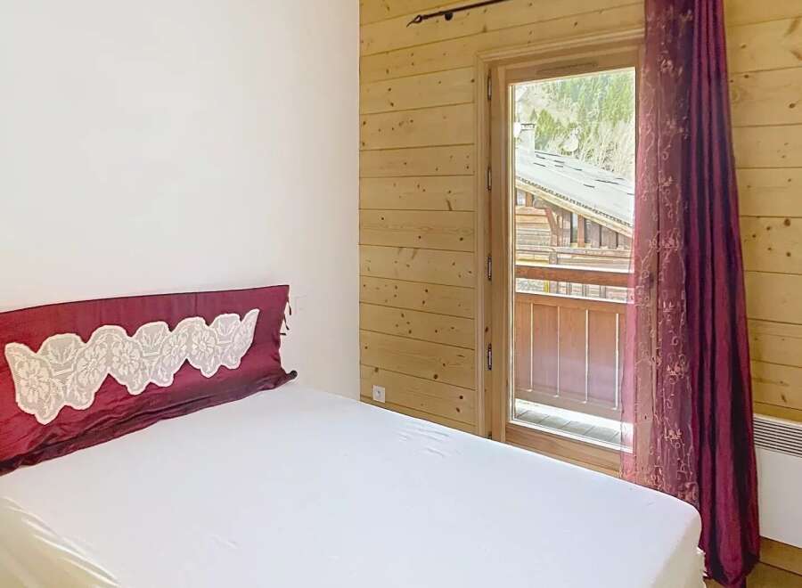 Discover the charm of this cozy bedroom featuring a comfortable bed and a touch of elegance.
