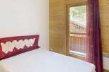 Discover the charm of this cozy bedroom featuring a comfortable bed and a touch of elegance.