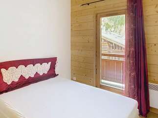 Discover the charm of this cozy bedroom featuring a comfortable bed and a touch of elegance.