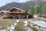 Discover this stunning wooden chalet nestled in a picturesque mountain setting.