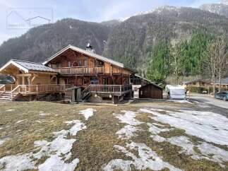 Discover this stunning wooden chalet nestled in a picturesque mountain setting.