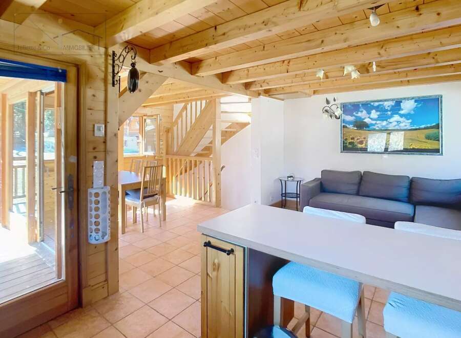 Discover this charming property featuring a warm and inviting interior with wooden accents throughout.