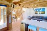 Discover this charming property featuring a warm and inviting interior with wooden accents throughout.
