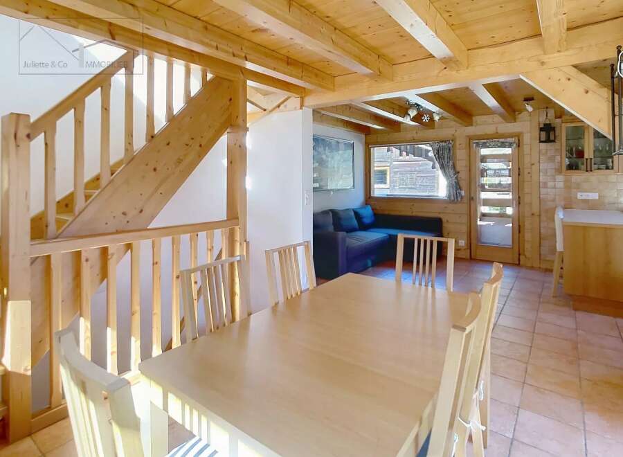 This charming property boasts a warm and inviting interior with exposed wooden beams and a cozy atmosphere.