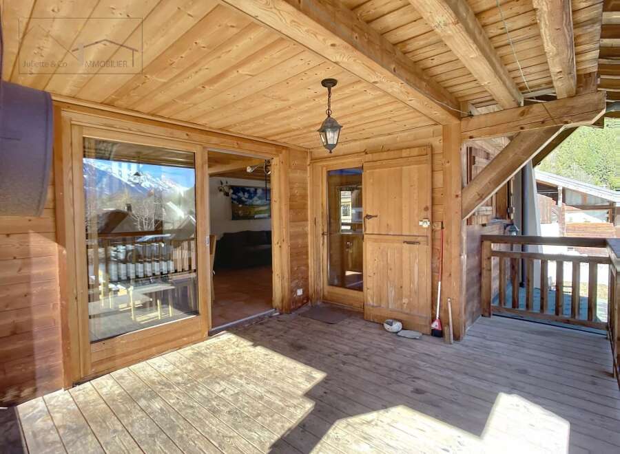 Discover the charm of this wooden chalet, featuring a spacious outdoor deck perfect for enjoying the mountain views.