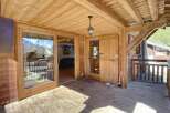Discover the charm of this wooden chalet, featuring a spacious outdoor deck perfect for enjoying the mountain views.