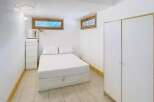 Discover this cozy bedroom featuring a comfortable bed, perfect for relaxation.