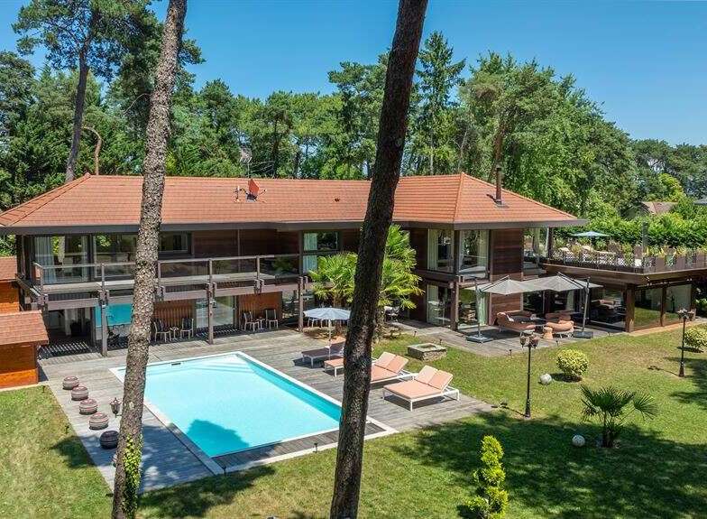 This stunning property boasts a luxurious outdoor pool, perfect for relaxation and entertainment.