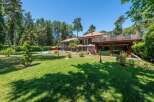 Discover luxury living in this stunning property, showcasing a meticulously manicured lawn and a beautiful outdoor space.