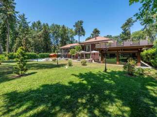Discover luxury living in this stunning property, showcasing a meticulously manicured lawn and a beautiful outdoor space.