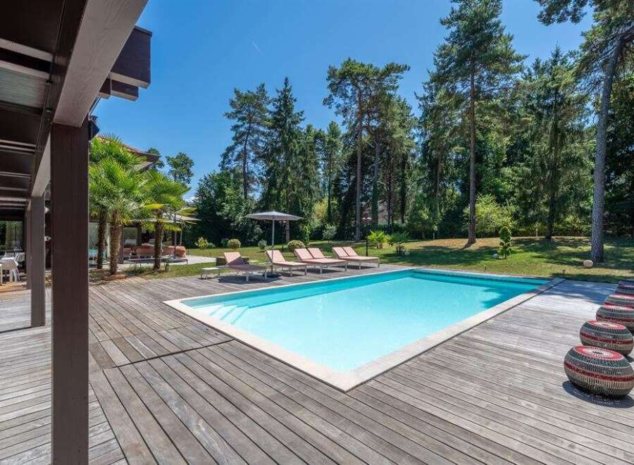 Enjoy the ultimate relaxation in this stunning property featuring a private pool and expansive wooden deck.