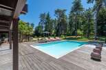 Enjoy the ultimate relaxation in this stunning property featuring a private pool and expansive wooden deck.