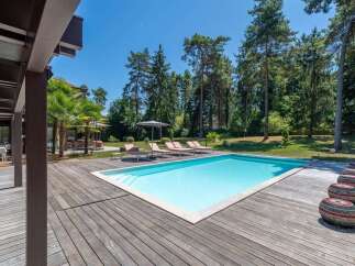 Enjoy the ultimate relaxation in this stunning property featuring a private pool and expansive wooden deck.