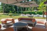 Enjoy luxurious outdoor living in this stunning property! This image showcases a beautifully designed patio area, complete with stylish seating and a modern round table.